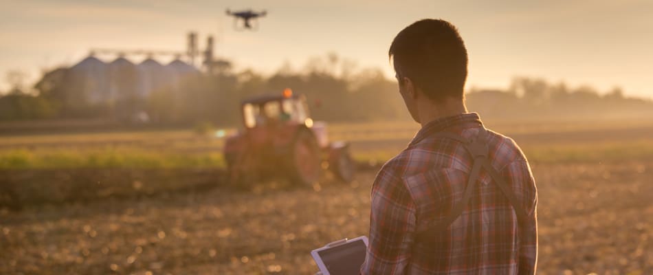 attractive farmer navigating drone