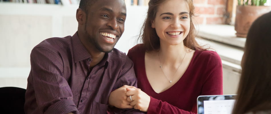 smiling multiracial couple customers shaking hands